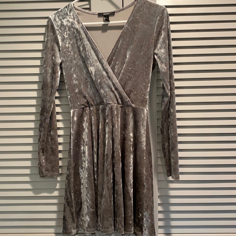 Silver long sleeved flare dress with a low cut top